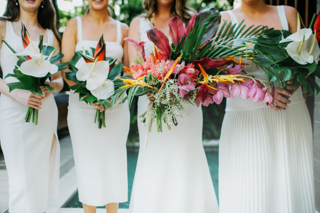 How long does it take to plan a wedding in Bali? 4 Bride & bridesmaids with floral arrangements
