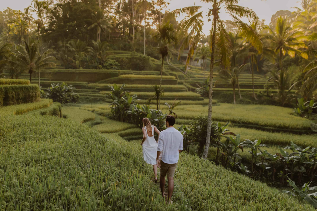 What to pack for your Bali wedding & honeymoon 7 Couple walking through rice fields
